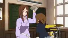 Yui holding money over Mio's head