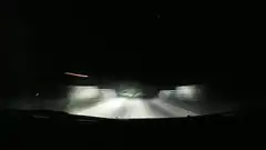 car driving on dark road at night