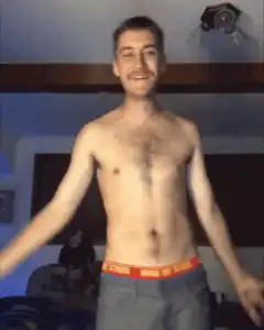 Shirtless man flexes and screams