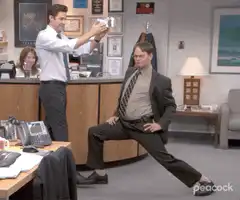 Jim puts a hat on Dwight