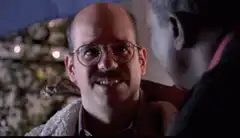 Carl Weathers and Ted Danson stare at each other