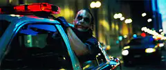 Joker laughing in police car