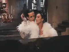 Man and woman in white feathers dancing