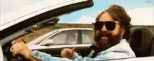 Dude giving a thumbs up in a car