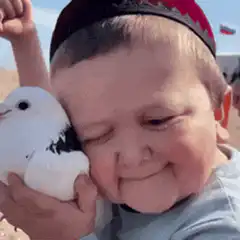 Baby holding a white dove