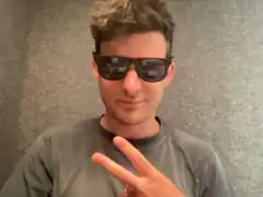 man in sunglasses making peace sign