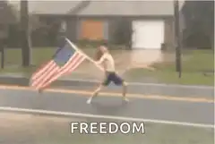Shirtless man running with American flag