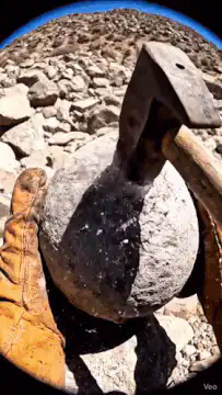 hammer breaks rock to reveal kitten in amethyst