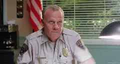 Chief Wiggum throws a cup at The Dude