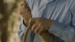 Man tying a knot in a rope