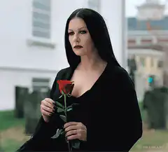 Morticia Addams holding a red rose
