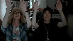 Two people doing a synchronized dance move