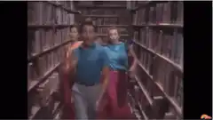 Three people dancing in a library