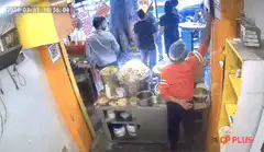 man in red shirt kicks door