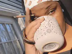 woman smoking and drinking from mug