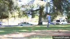 Man runs with suitcase to park bench