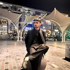 Man sitting on sphere at night