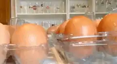 bald man peeks over eggs
