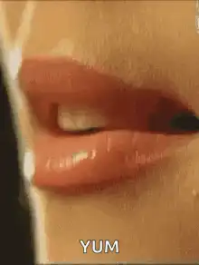 Woman licking lips with yum text
