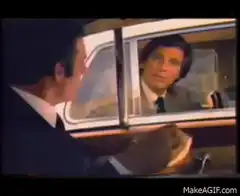 Man passing jar of mustard between cars