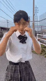 Girl in school uniform punches camera