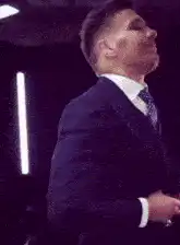 Man in suit dancing and smiling