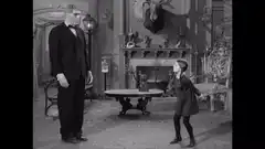 Little girl dances for tall man