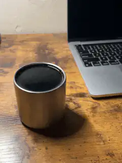 metal cup on wooden desk