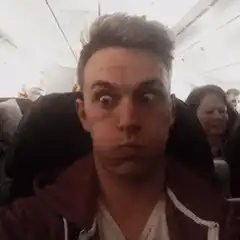 Man making funny face on airplane