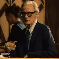 Bill Nighy raising a glass