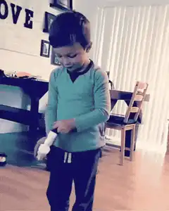 Boy puts on socks and laughs