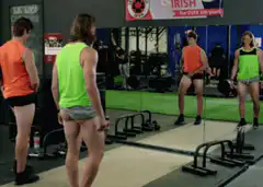 Man lifts shirt to show large bulge in gym