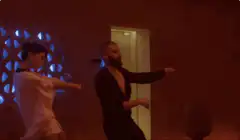 Man and woman dancing in red room