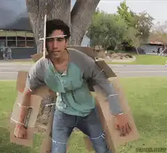 Man in cardboard camouflage suit