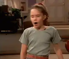 Girl pointing and looking confused