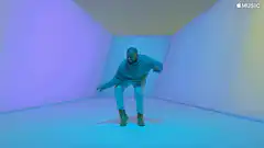 Kanye West dancing in a blue room