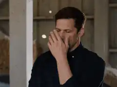 Man covers face in embarrassment