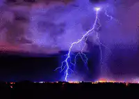 Lightning strikes over city and beach