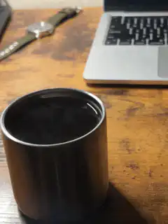 steaming metal cup on desk