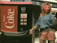 Woman in pink glasses by Coke machine