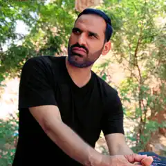 Man in black shirt looking up with a skeptical expression