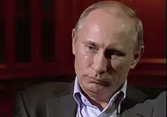 Vladimir Putin laughing and facepalming