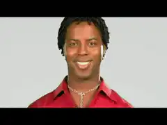 Man in red shirt smiling and laughing