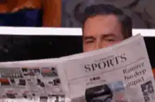 Man lowers newspaper to look up
