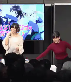 Two women on stage at anime event