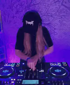 DJ with long blonde hair mixing music