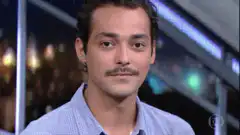 Man with mustache smirking