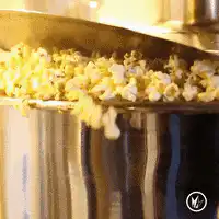 Popcorn falling from a metal scoop