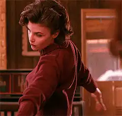Woman in red sweater turns around