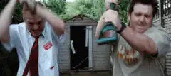 Two men smashing a shed with axes